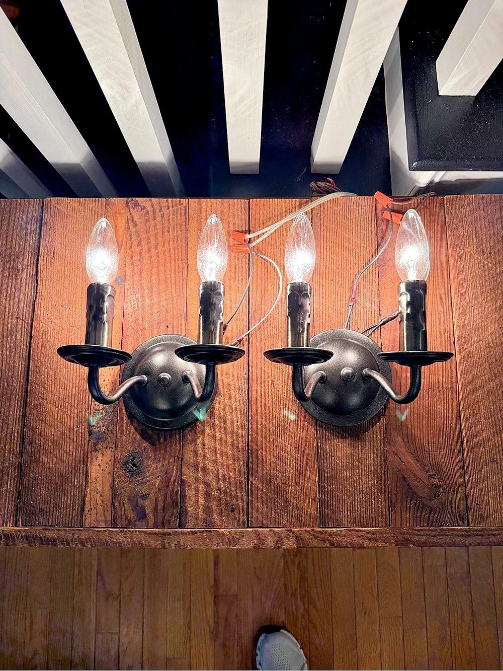 Pair of two-light oil rubbed bronze painted hardwired wall sconces